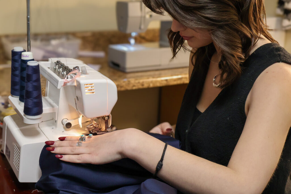 An Elegant Brides seamstress performing alterations on a prom dress.