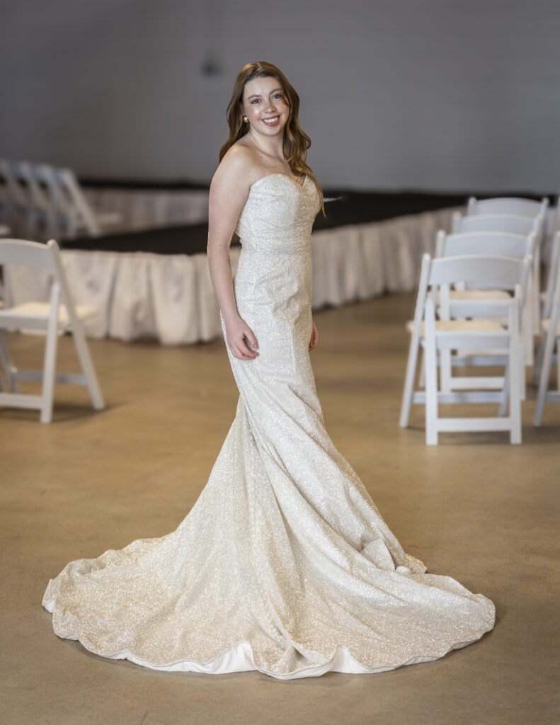 Elegant bride wearing a glamorous wedding dress that is strapless and covered in glitter.