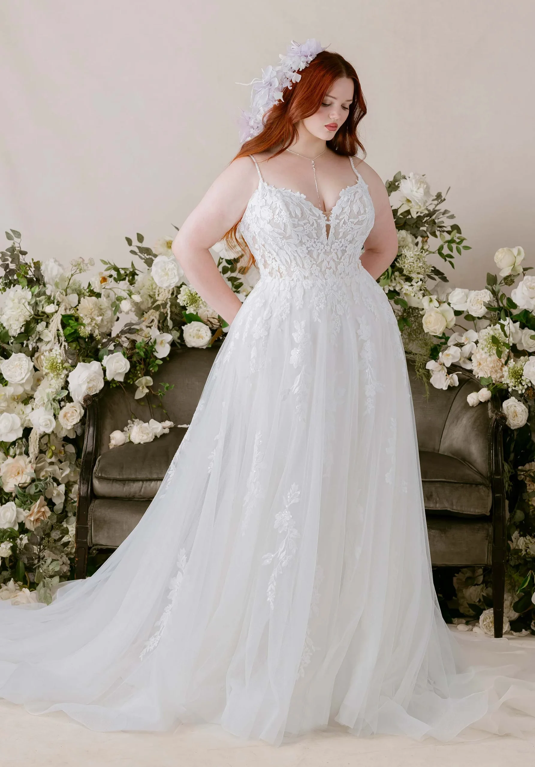Morilee's Sognare wedding dress featuring an A-Line fit, floral lace appliques flowing from the bodice down the skirt, and a plunging neckline.