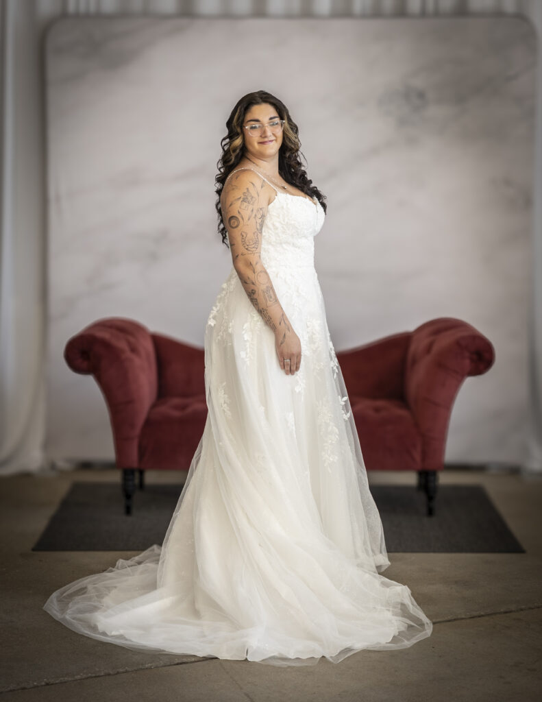 Rebecca Ingram's Catherine wedding dress featuring intricate lace appliques on the bodice and running down the skirt.