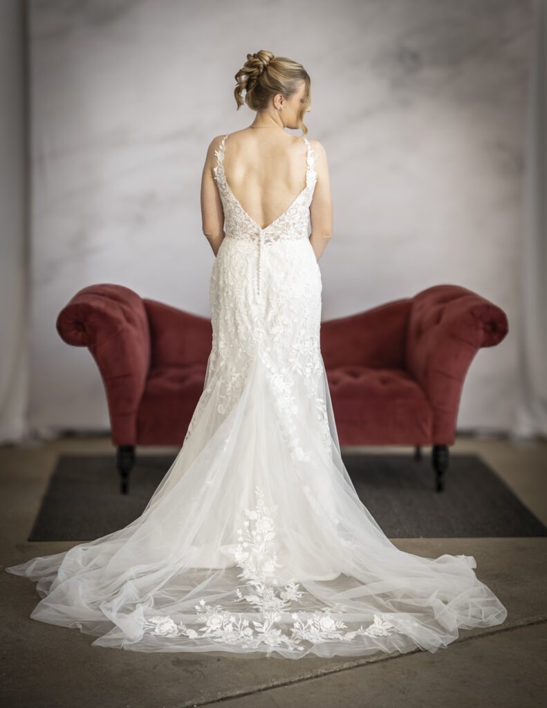 Rebecca Ingram's Mandy wedding dress, featuring floral lace appliques running from the bodice down the skirt and along the hem of the skirt.