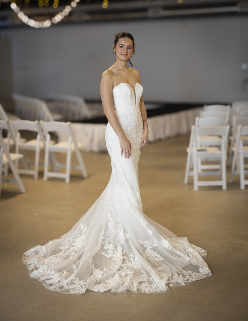 Rebecca Ingram's teagan wedding dress featuring a fit and flare silhouette, lace appliques along the bottom of the skirt, floral lace appliques along the bodice, and a romantic sweetheart neckline.