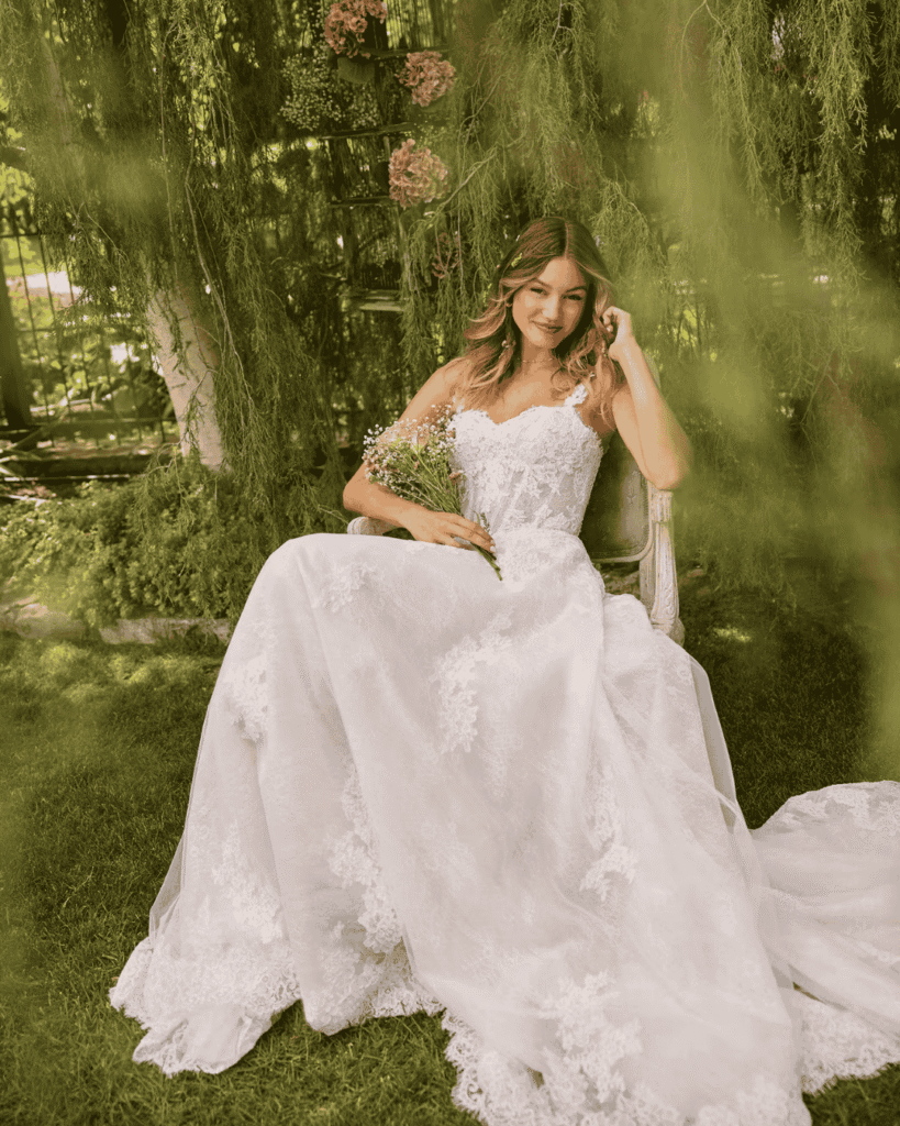 A youthful Rebecca Ingram wedding dress with a full skirt and lacy appliques.