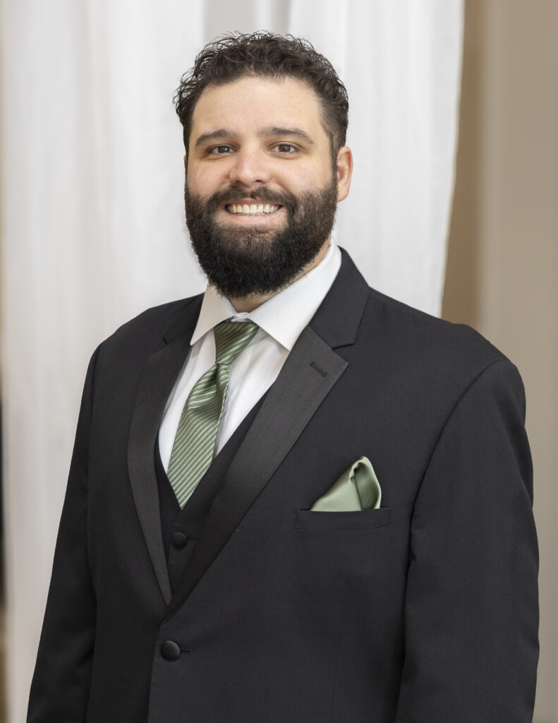 A groom wearing a tuxedo from Elegant Brides.