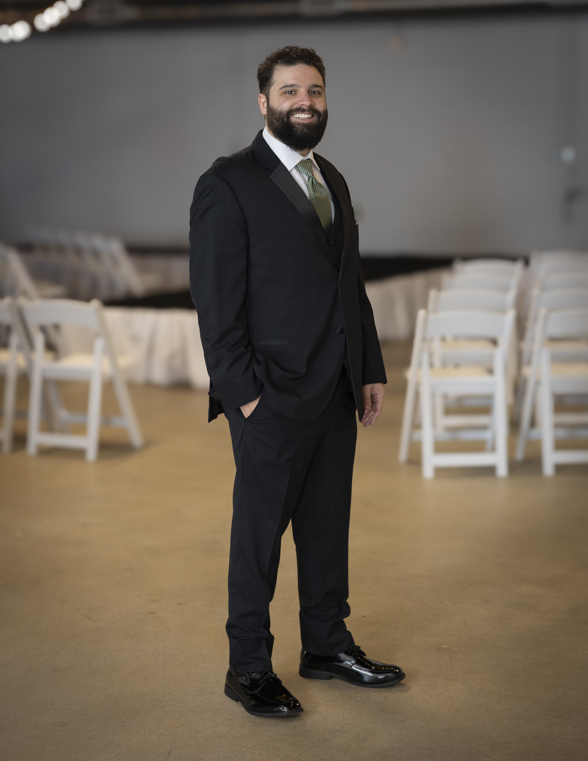 An Elegant Brides model wearing a tuxedo.