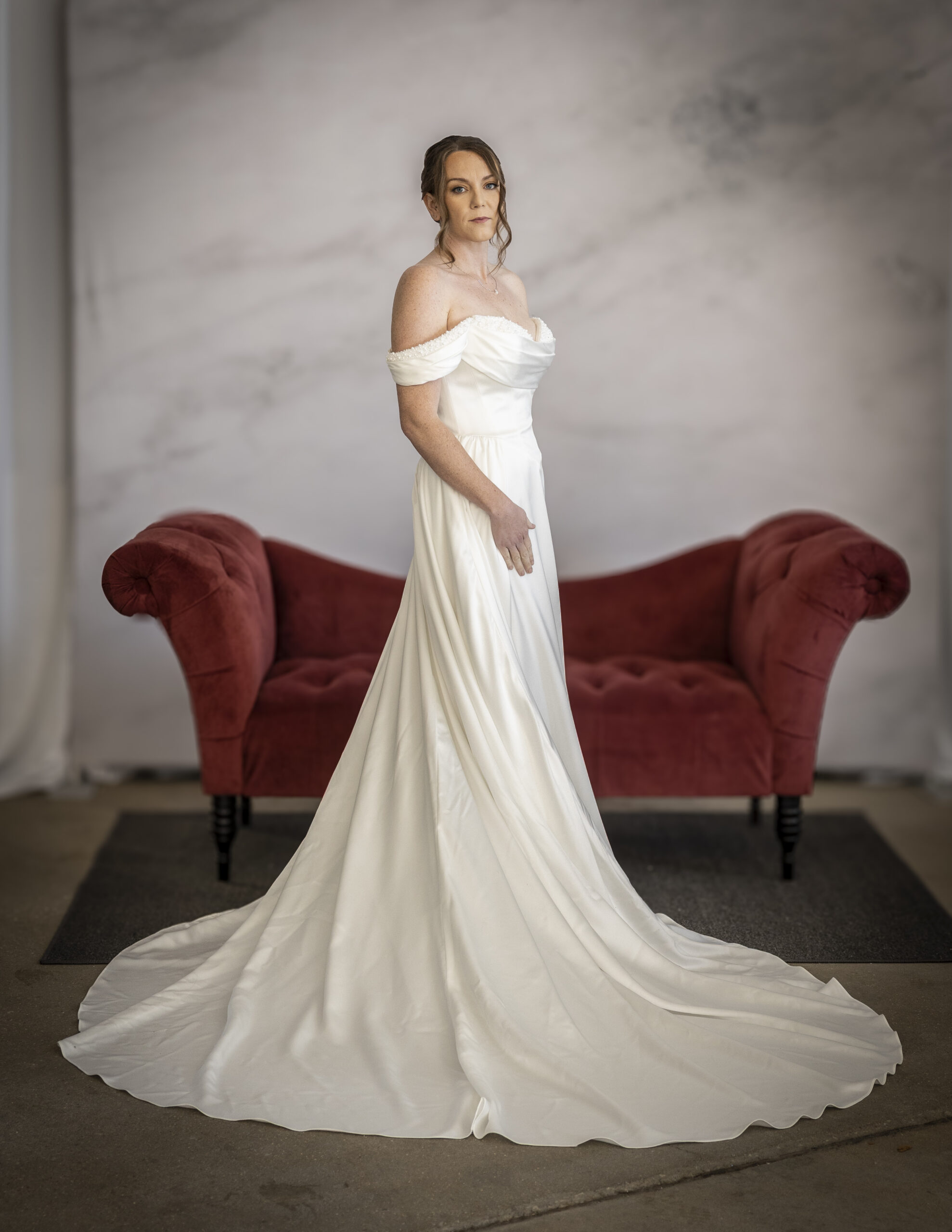 An Elegant Bride wearing Stella York's style 8236, a modern, glamorous wedding dress with pearl details at the bust.