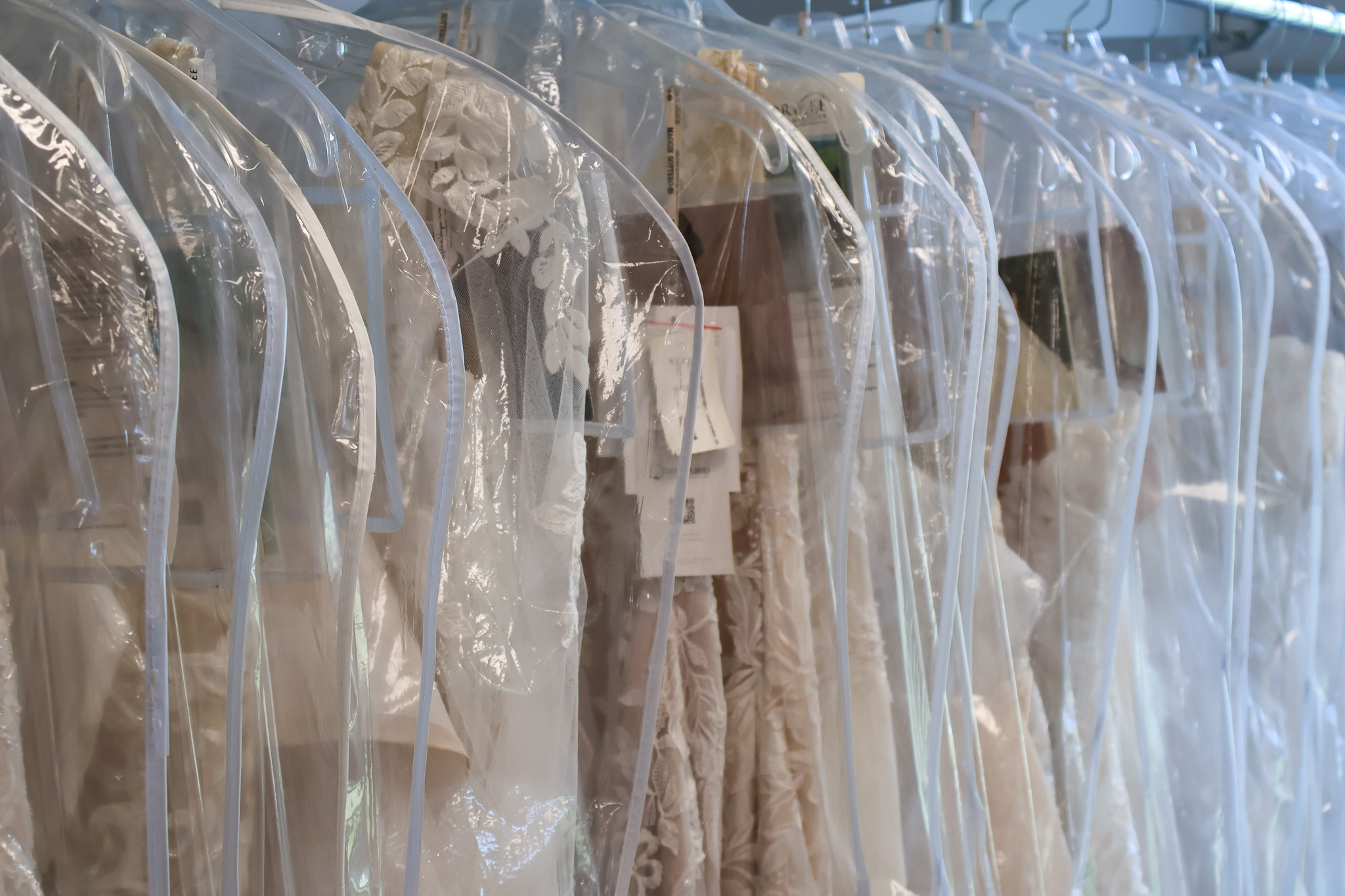 Bridal gowns in bags at Elegant Brides.